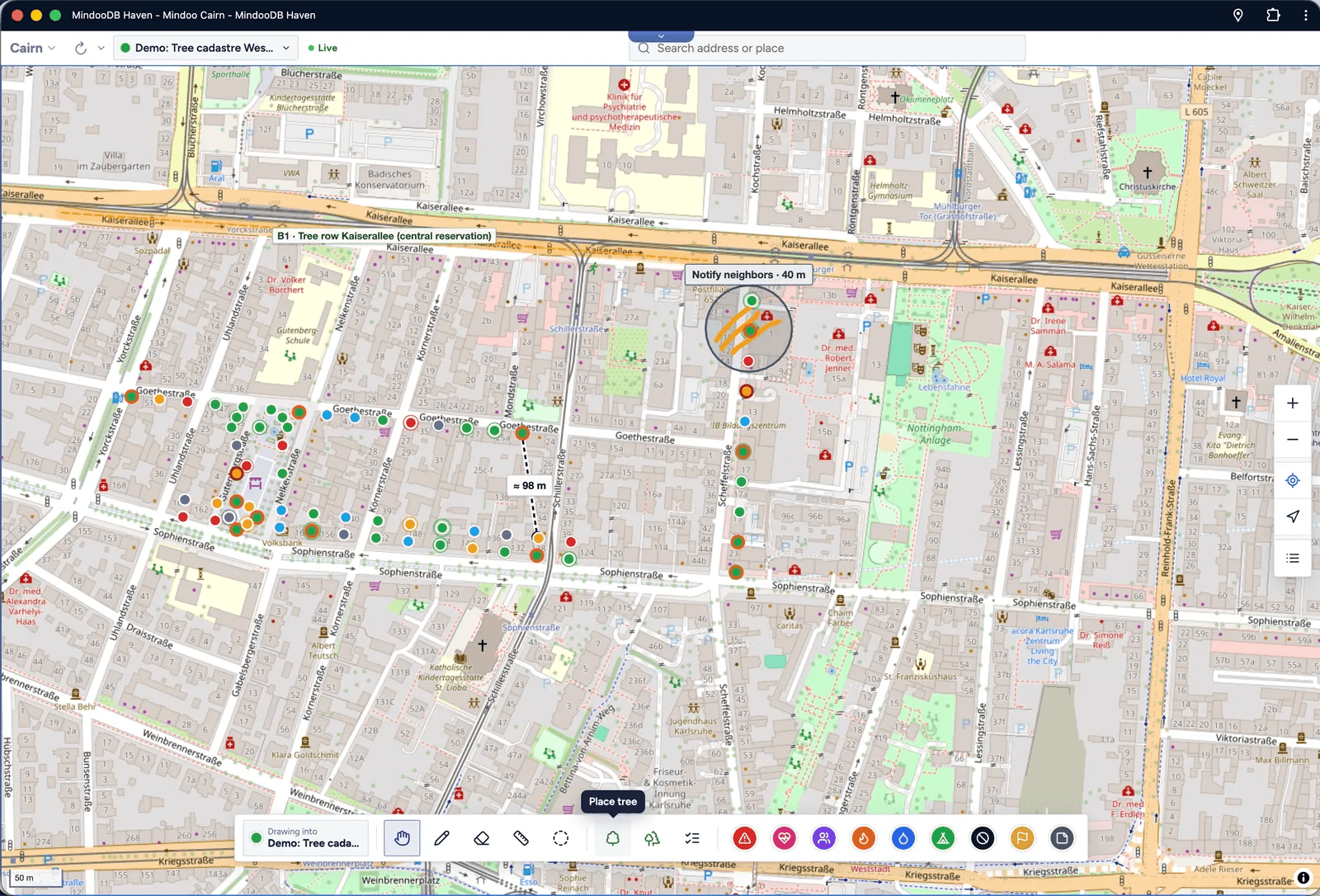 Mindoo Cairn map of a city district with colored tree markers, a tree row along a central reservation, a circled area, a dashed 98 m distance line, and the drawing toolbar at the bottom